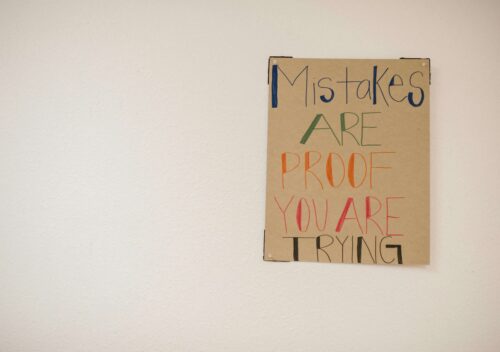 Poster on a wall saying, "Mistakes are proof you are trying."