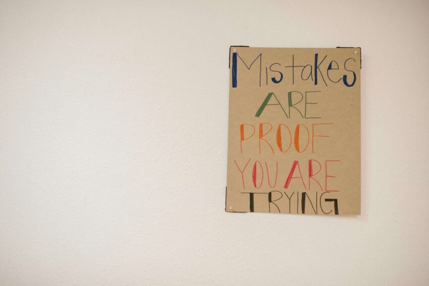 Poster on a wall saying, "Mistakes are proof you are trying."