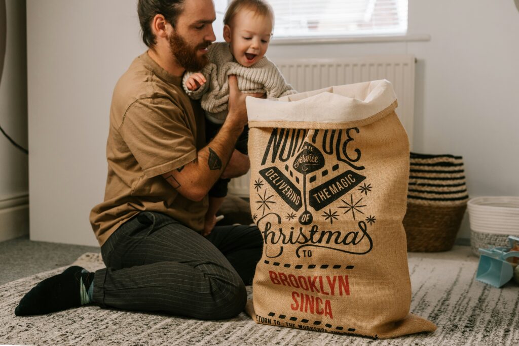 Dad and son unwrapping Christmas gifts